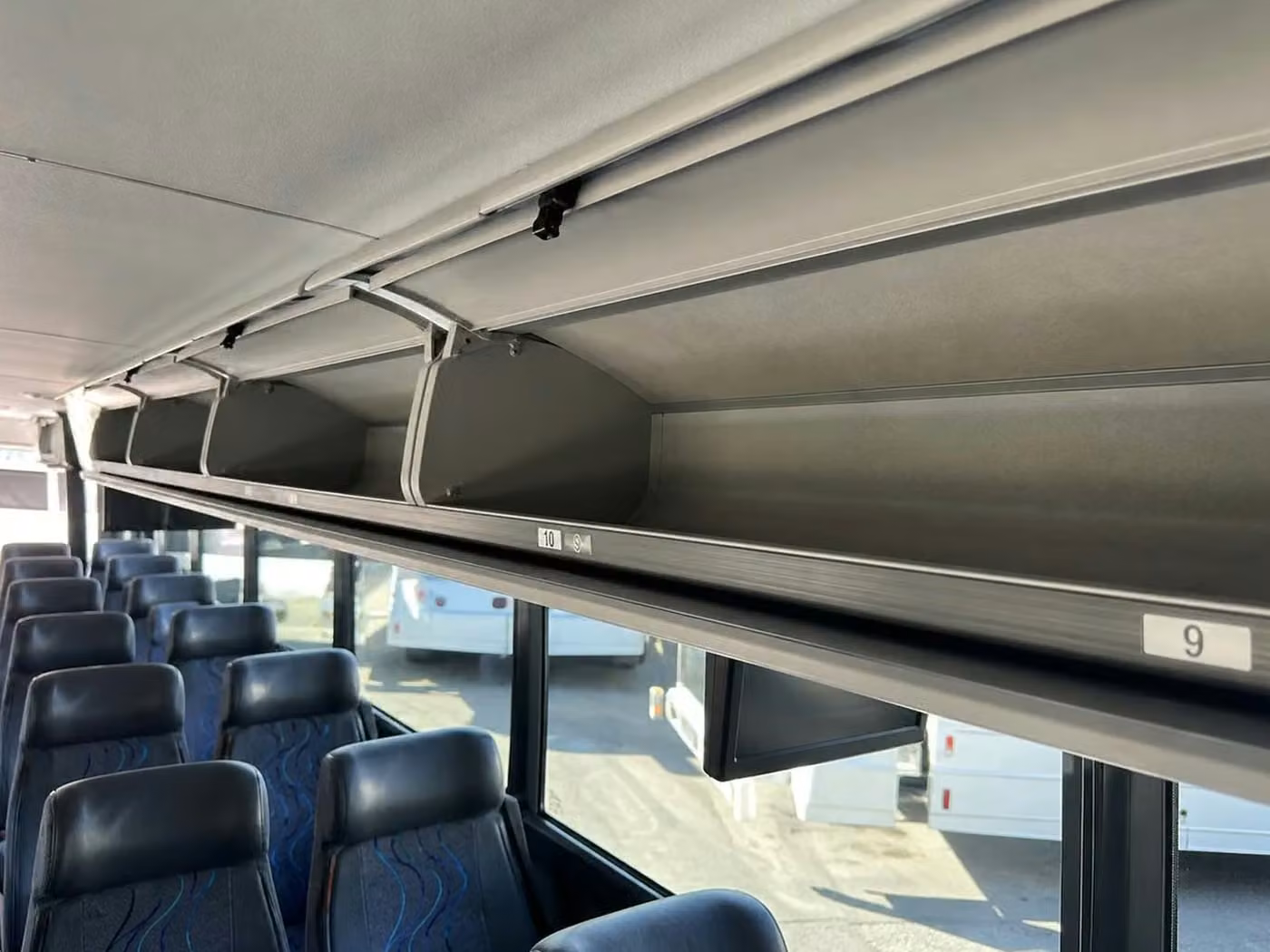 tucker charter bus overhead storage